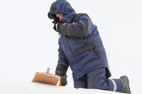 Assembler at the construction site with a brush in his hands 스톡 사진