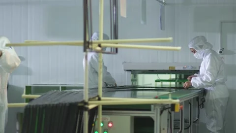 Assemblers assemble a plastic TV frame on a conveyor Stock Footage 162319242