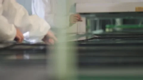 Assemblers assemble a plastic TV frame on a conveyor Stock Footage 162363438