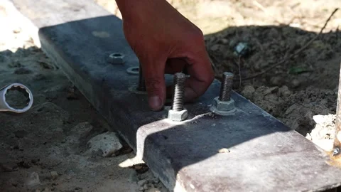 Assembler's hands tightening a Nut onto a Bolt Stock Footage 258645568