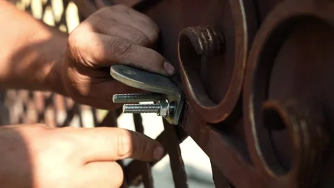 Assembler's hands tightening a Nut onto a Bolt Video stock 261500586