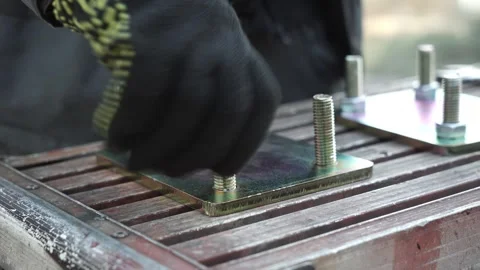 Assembler's hands tightening a Nut onto a Bolt Video stock 263801819