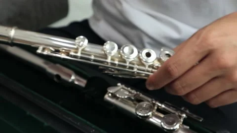 Assembles a flute from a case Stock Footage 201145006