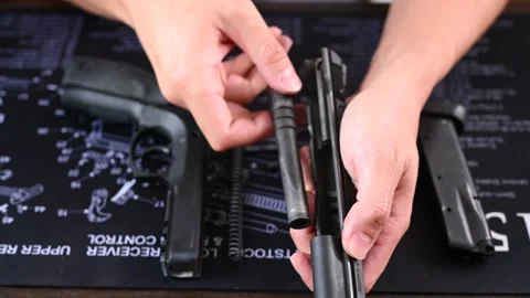 Assembling a 9mm pistol on a cleaning mat Stock Footage 146619120