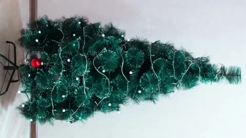 Assembling and decorating a Christmas tree, Vertical stop motion video Stock Footage 165740147