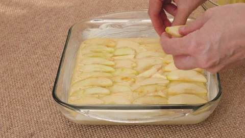 Assembling apple cake. Fresh peeled apple slices on top of dough Stock Footage 169447593