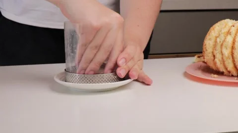 Assembling bento cake by layering sponge in ring mold and soaking with milk. Stock Footage 317154942