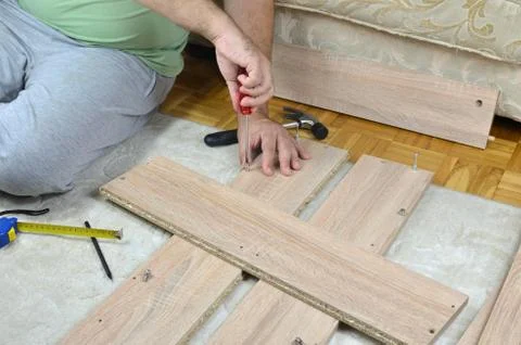 Assembling a Cabinet with a Screwdriver Stock Photos