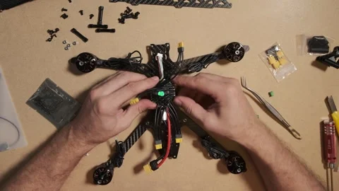 Assembling Carbon Fiber FPV Racing Drone Frame with Electronics Stock Footage 328649936