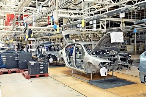 Assembling cars on conveyor line Stock Photos