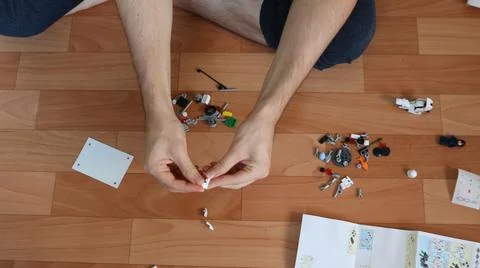Assembling children's construction sets on the floor in the room Stock Photos