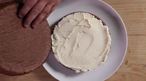 Assembling a chocolate cake Stock Footage 64049296