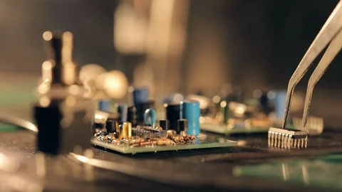 Assembling a circuit board. Putting microcircuit on PCB with tweezers Video stock 97603728