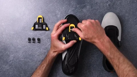 Assembling cleats on cycling shoes Stock Footage 155483631