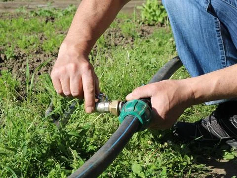 Assembling a compression fitting with a valve for garden irrigation Stock Photos