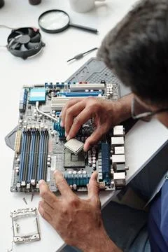 Assembling Computer Hardware Components on Workspace Foto stock