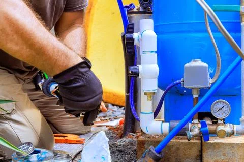 Assembling connection between water well a home water system Foto stock