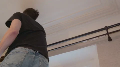 Assembling a cornice eaves for curtains designer man Stock-Footage 148745862