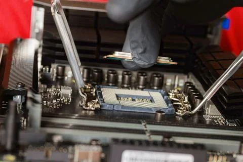 Assembling desktop computer with plug in CPU to motherboard socket 库存照片