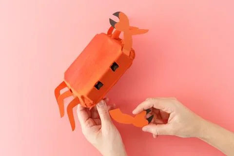 Assembling details of upcycled egg box crab craft, creative process in prog.. Stock Photos