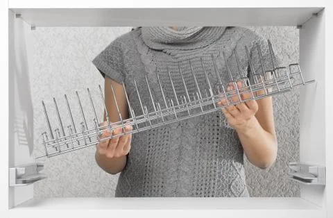Assembling dish rack inside kitchen cupboard Stock Photos