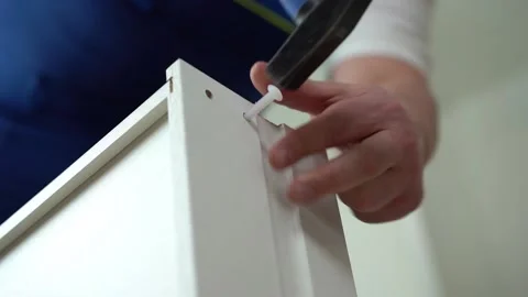 Assembling a drawer for a table by a carpenter. Professional help at home Stock Footage 221814126