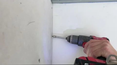 Assembling drywall on construction site. Apartment reconstruction. Stock Footage 154604881