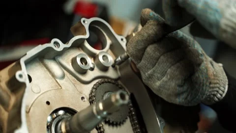 Assembling the engine for the ATV, screwing the bolts into the motor Video stock 160490903