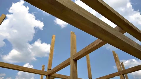 Assembling the frame of the building made of wooden beams Stock Footage 220611185