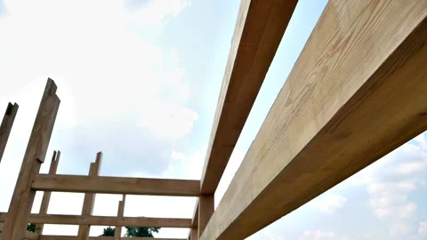 Assembling the frame of the building made of wooden beams Stock Footage 220611230