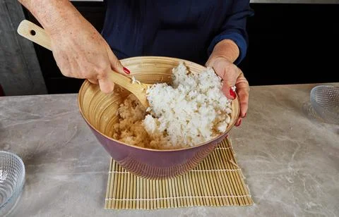 Assembling fresh sushi rolls in the kitchen Stock Photos