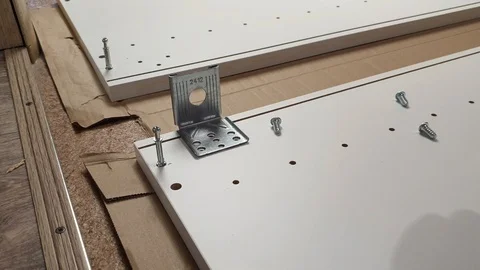 Assembling the furniture yourself, the man assembles the kitchen Cabinet Stock Footage 117587108