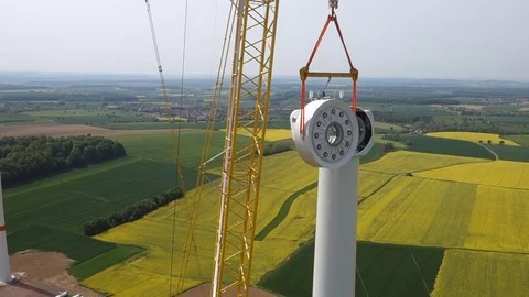 Assembling a generator on transmission towers in wind power plant. Aerial. Stock-Footage 73123769