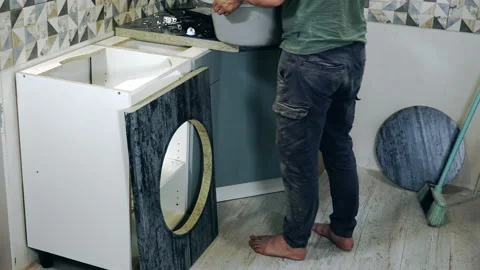 Assembling kitchen furniture by a worker, timelapse. Stock Footage 201216158