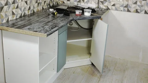 Assembling kitchen furniture by a worker, timelapse. Stock Footage 206126176