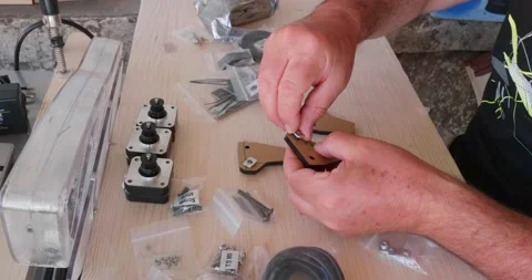Assembling a laser engraver from an assembly kit sent by the manufacturer. Sc Stock-Footage 156889218