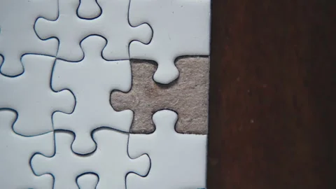 Assembling the last piece of the jigsaw puzzle Stock Footage 318348283