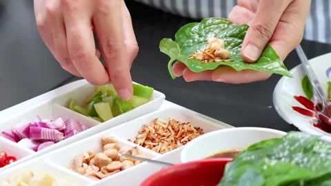 Assembling Leaf Wraps with Fresh Ingredients Vídeos de archivo 311439601