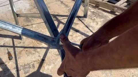 Assembling Metal Frame Parts with Bolts and Nuts Stock Footage 345208243