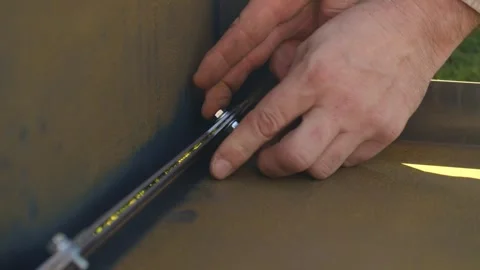Assembling metal grill component with careful hand adjustment Stock Footage 323874695