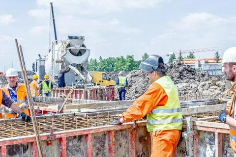 Assembling metal skeleton, welder is welding tied reinforcing rod Stock Photos