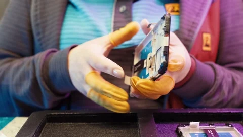 Assembling a mobile device. Repair of equipment and phones. close up of Stock Footage 203929255