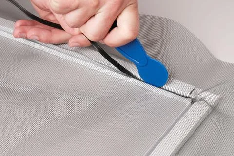 Assembling  mosquito net for  window, installing  seal in an aluminum profile Stock-Fotos