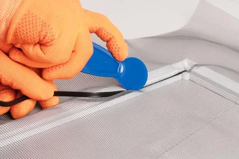 Assembling  mosquito net for  window, installing  seal in an aluminum profile Фото