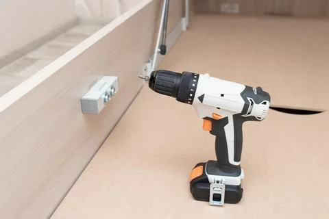 Assembling a new bed using a screwdriver Stock Photos