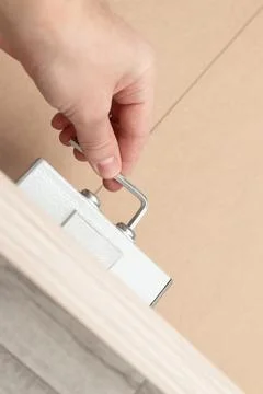 Assembling a new bed using a screwdriver Stock-Fotos