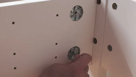 Assembling a New wooden bed in Bedroom. Man tighten by hex key the furnitur.. Stock Footage 247920829