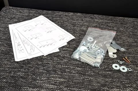 Assembling parts of sofa with instruction Stock Photos