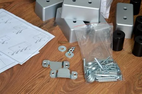 Assembling parts of sofa with instruction Stock Photos