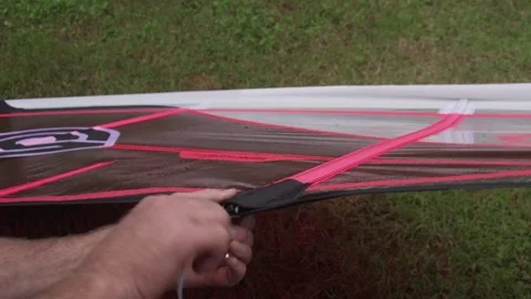 Assembling pink / red windsurf sail with allen key. Maui Hawaii Stock Footage 136265649